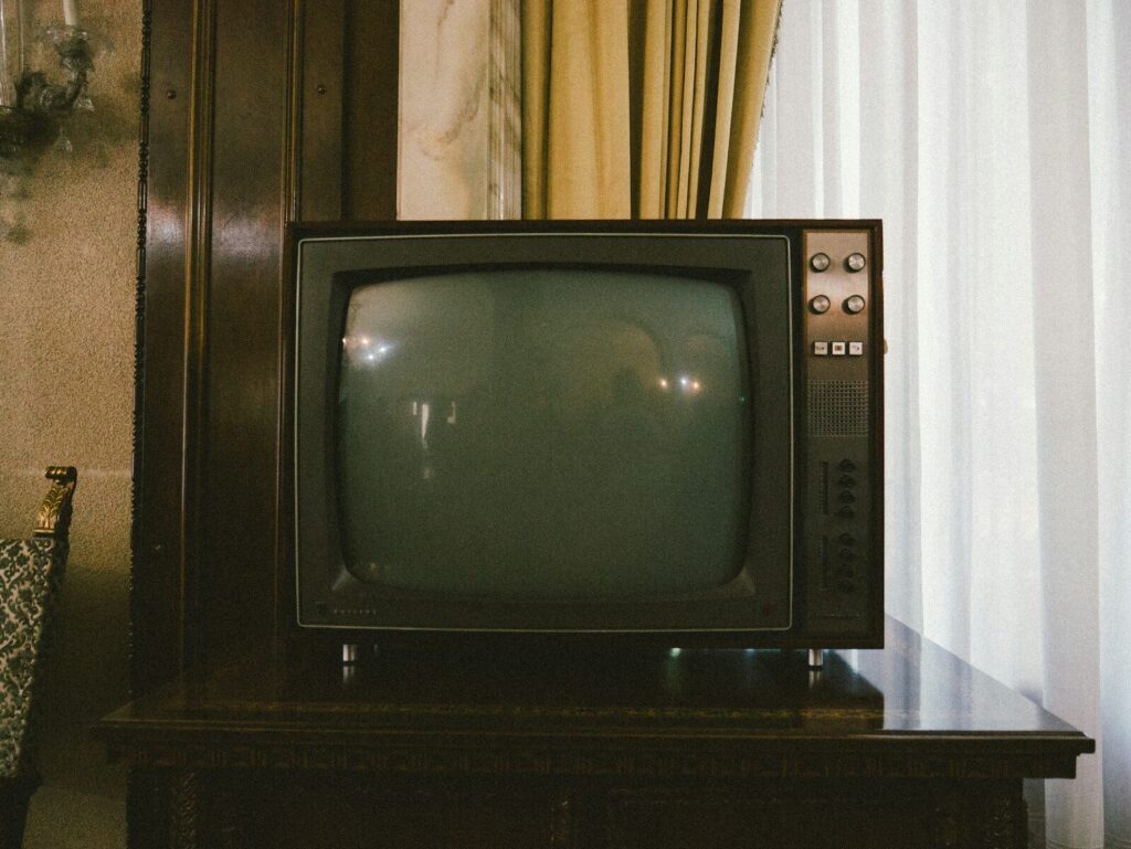 Stary telewizor kineskopowy w salonie - klimat kreskówek z lat 90.